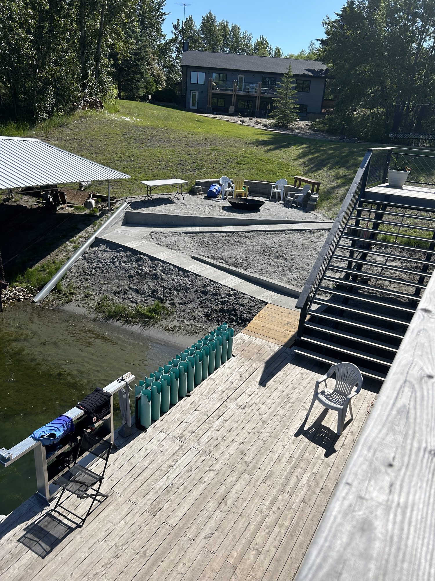 The dock and fire pit at Shalom Park — three generations gathering at the family waterski estate